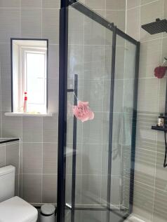 A clean and modern bathroom with a glass shower...