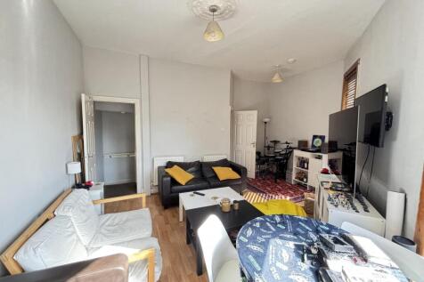 A spacious and welcoming living room with ample...