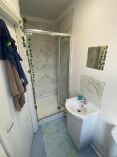 A clean and modern bathroom with a shower enclo...