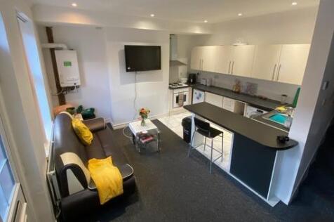 A bright and modern living room featuring comfo...