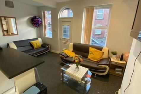 A well-lit, spacious living room with contempor...