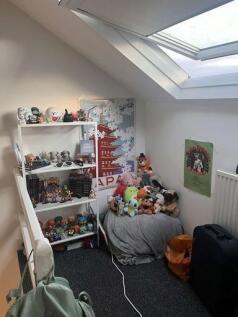 A cozy bedroom filled with a variety of toys an...