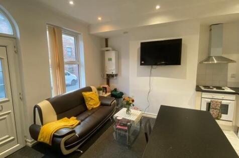 A modern, well-lit living room featuring a comf...