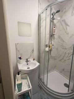 A clean and modern bathroom featuring a shower ...