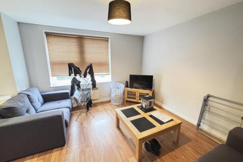 A cozy living room featuring a comfortable dark...