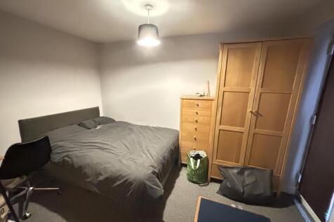 A well-maintained bedroom featuring a double be...