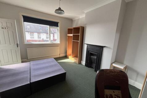 A bright and welcoming living room with a large...