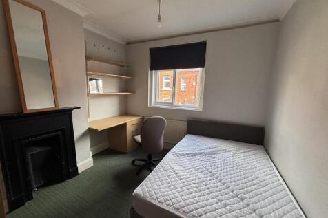 A well-lit, clean double bedroom featuring a co...