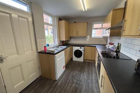 A bright and modern kitchen with ample storage ...