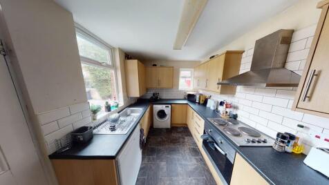 Bright and well-organized kitchen with ample co...