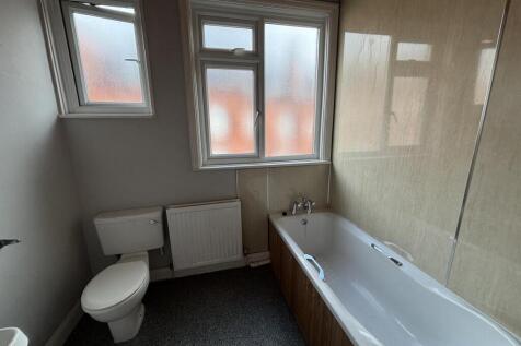A well-maintained bathroom featuring a large ba...