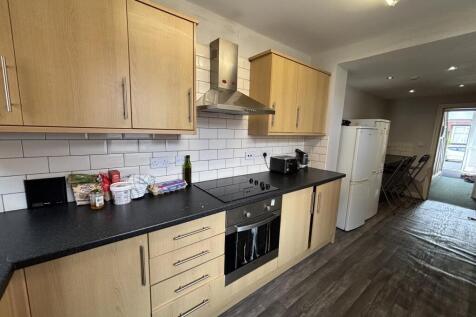 A well-maintained kitchen area with modern wood...