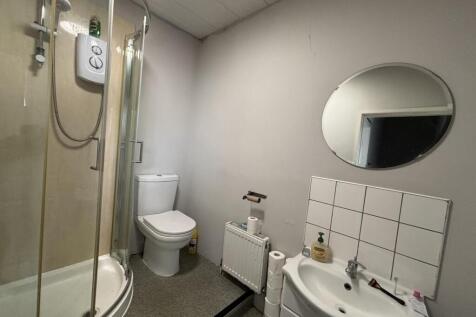 A clean and functional bathroom with a shower, ...