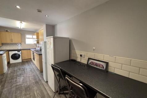 A modern kitchen area with a clean, well-mainta...