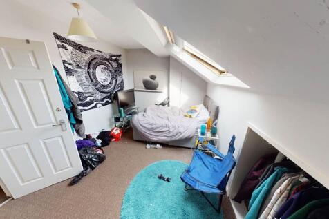 A cozy bedroom with a double bed and a skylight...