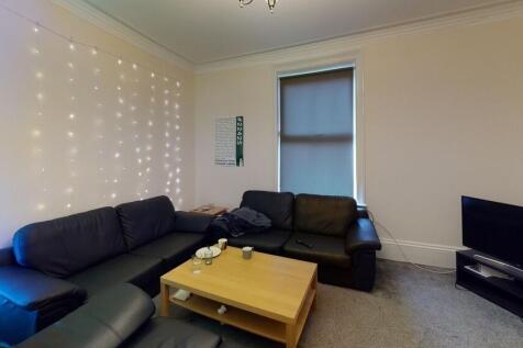 A spacious and modern living room featuring a l...