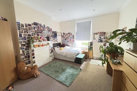 A bright and spacious master bedroom featuring ...