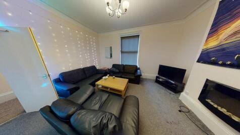 A spacious, modern living room featuring comfor...