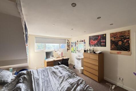 Bright and cozy bedroom featuring a large bed, ...