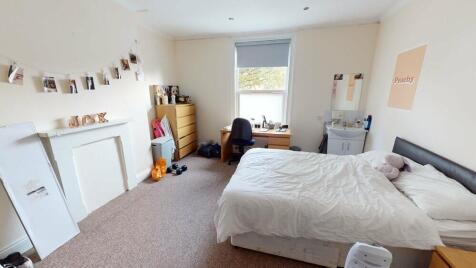 Bright and welcoming master bedroom featuring a...