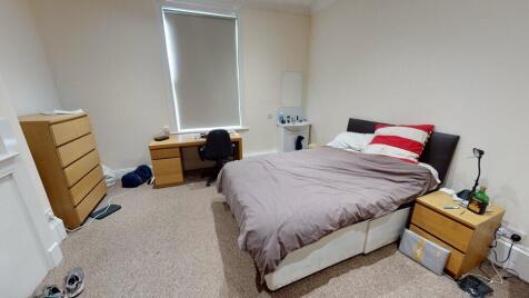 A cozy single bedroom with a comfortable bed, n...