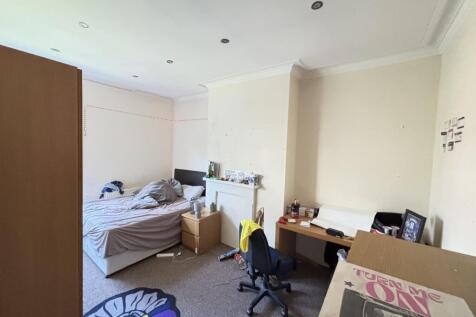 A comfortable bedroom featuring a single bed an...