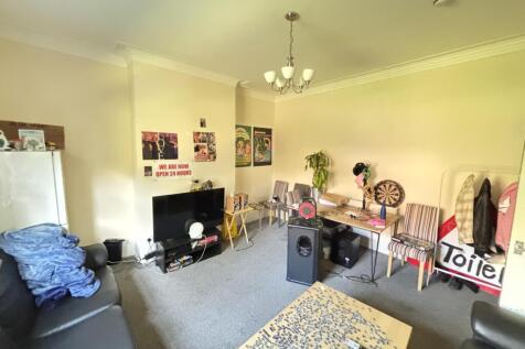 A welcoming and well-lit living room featuring ...