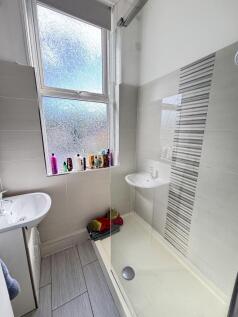 A bright and clean bathroom featuring a large s...