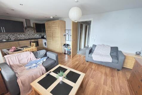 A spacious, well-lit living room featuring mode...