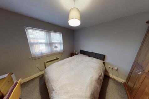 A cozy bedroom featuring a double bed with a ne...