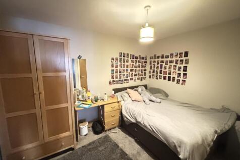 A spacious and well-lit double bedroom featurin...