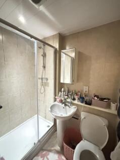 A clean and functional bathroom featuring a sho...