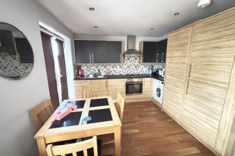 Modern, well-lit kitchen featuring sleek cabine...