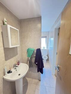 A spacious bathroom with a sink, mirror, and a ...