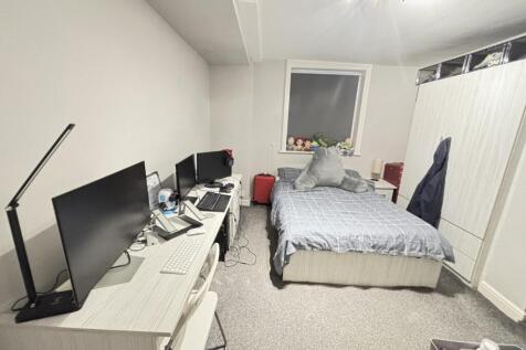 A spacious, well-maintained master bedroom feat...