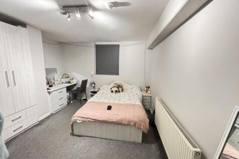 A bright and spacious master bedroom featuring ...