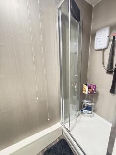 A modern bathroom featuring a shower enclosure ...