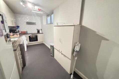 A compact and clean kitchen area with good natu...