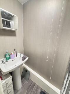 A well-maintained bathroom featuring a clean si...