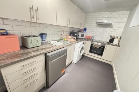 Modern and well-equipped kitchen featuring ampl...