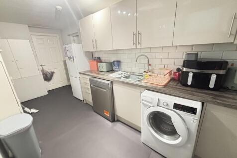 A bright, modern kitchen with white cabinets an...