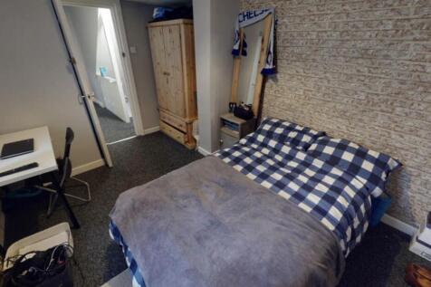 A cozy double bedroom with a neatly made bed fe...