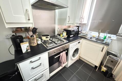 A modern kitchen with ample counter space, stai...