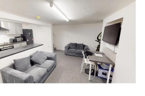 A modern and well-lit living room featuring com...