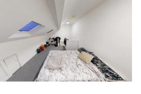 Bright and airy master bedroom with a comfortab...