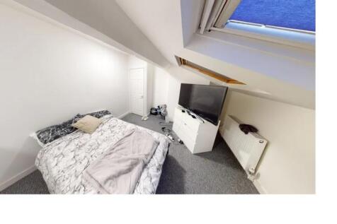 A bright and welcoming bedroom featuring a doub...