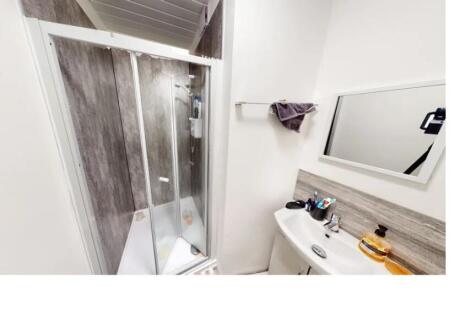 A clean and bright bathroom featuring a large s...