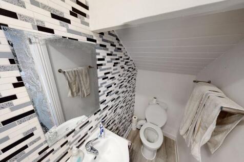 Bright and modern bathroom with ample lighting,...