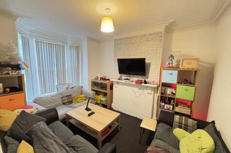 A bright and spacious living room with comforta...