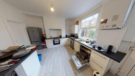 A spacious and well-lit contemporary living roo...